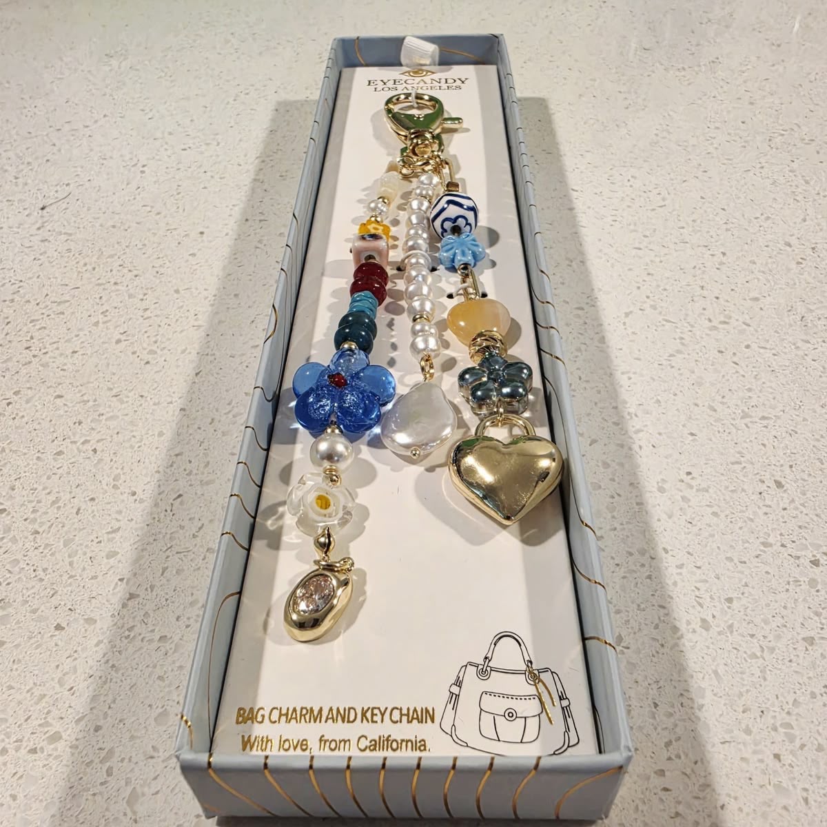 Eye Candy   
Gold, Blue & Pink Beaded Heart Key Bag Charm 💙