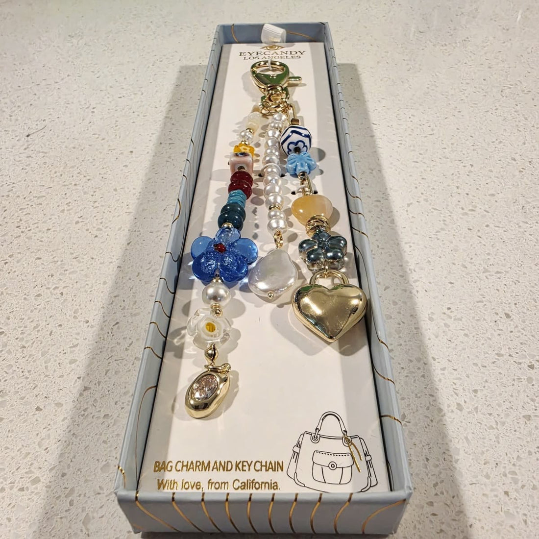 Eye Candy   
Gold, Blue & Pink Beaded Heart Key Bag Charm 💙